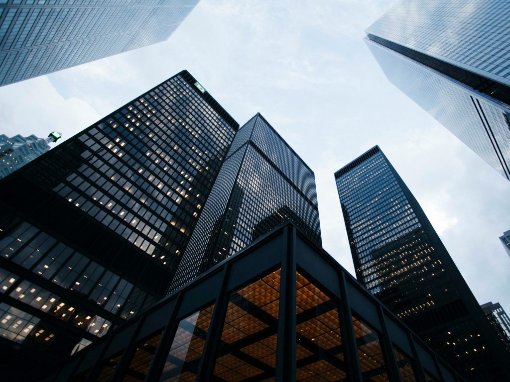 Large business buildings for an article with Franny Hsiao from Salesforce on why scaling enterprise AI requires overcoming architectural oversights that often stall pilots before production, a challenge that goes far beyond model selection.