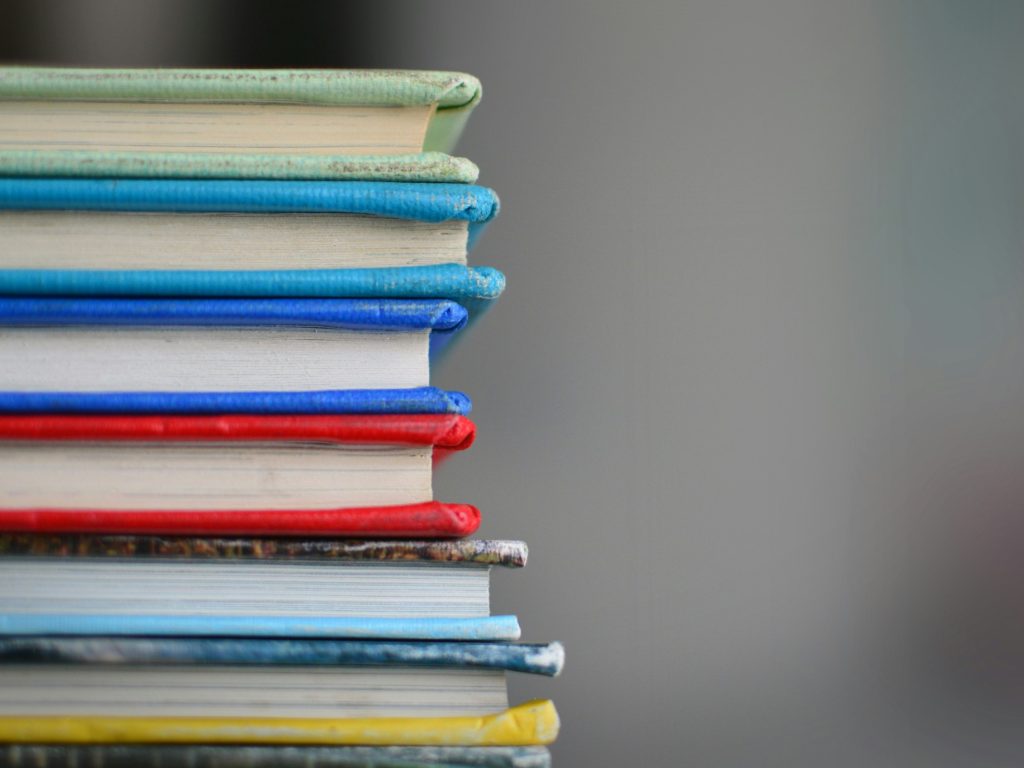 Stack of books illustrating the role of AI in education and how it presents both opportunities and challenges that demand careful navigation.